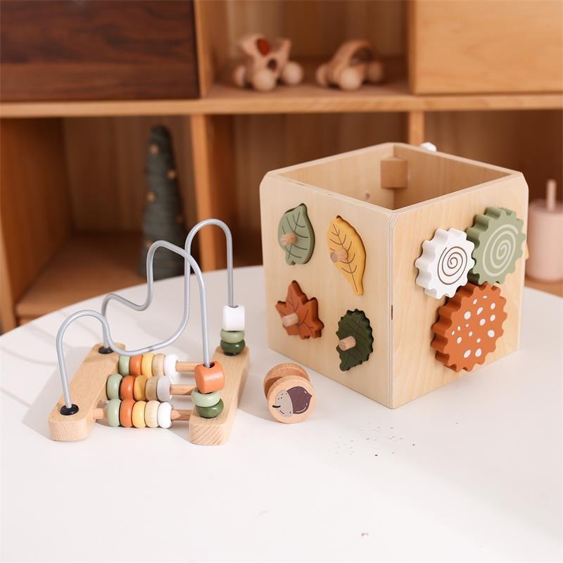 Leaf shape sorter side of the wooden activity cube with bead maze beside it