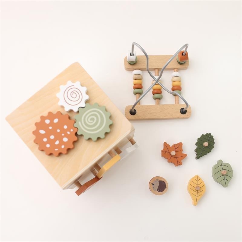 Top view of the wooden activity cube with bead maze and leaf pieces