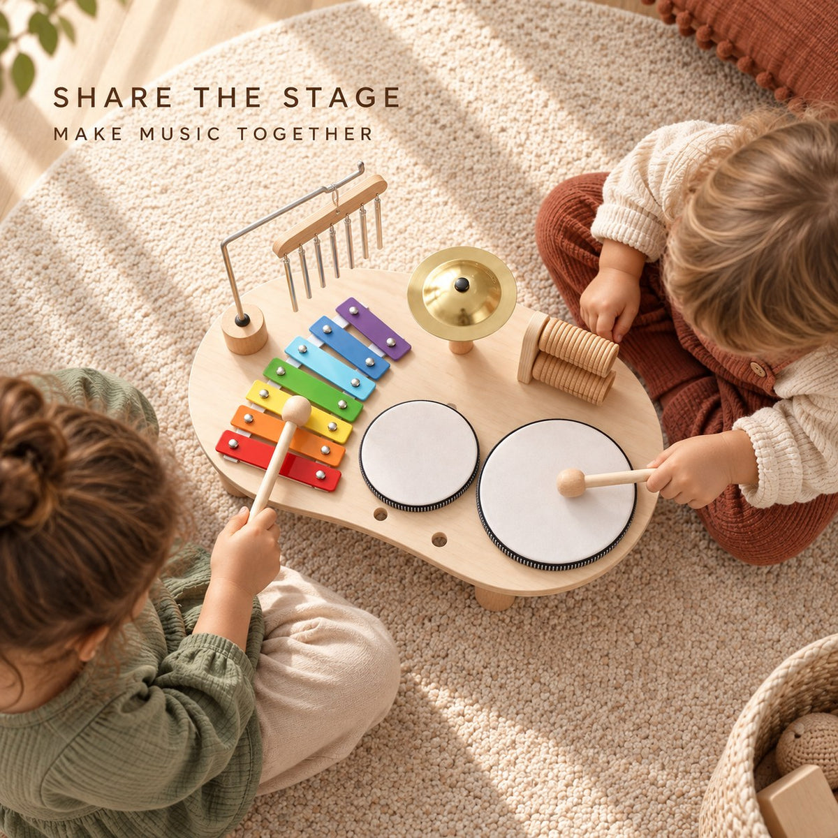 Two children playing music together on the wooden music table